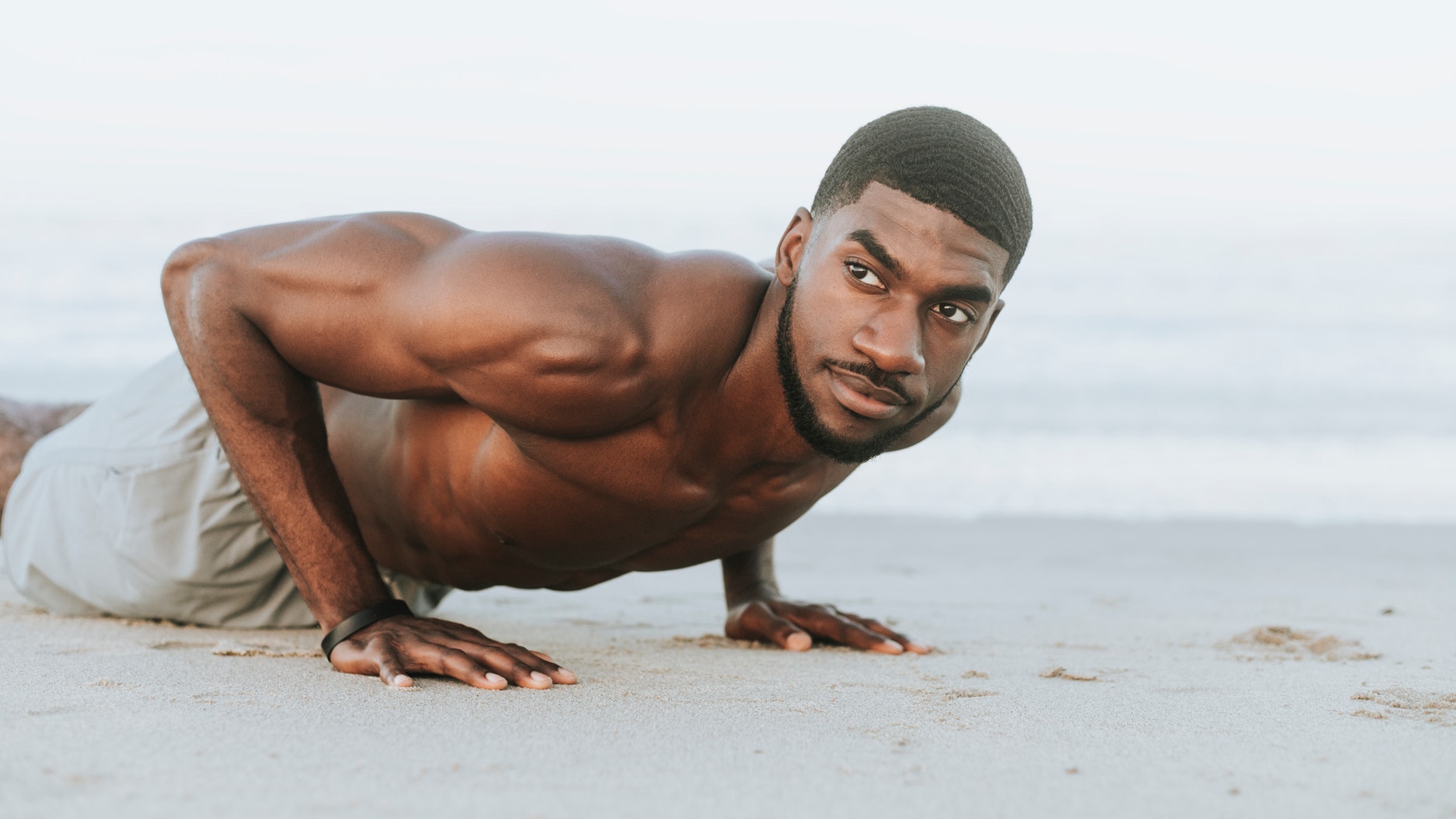 man pushups on beach