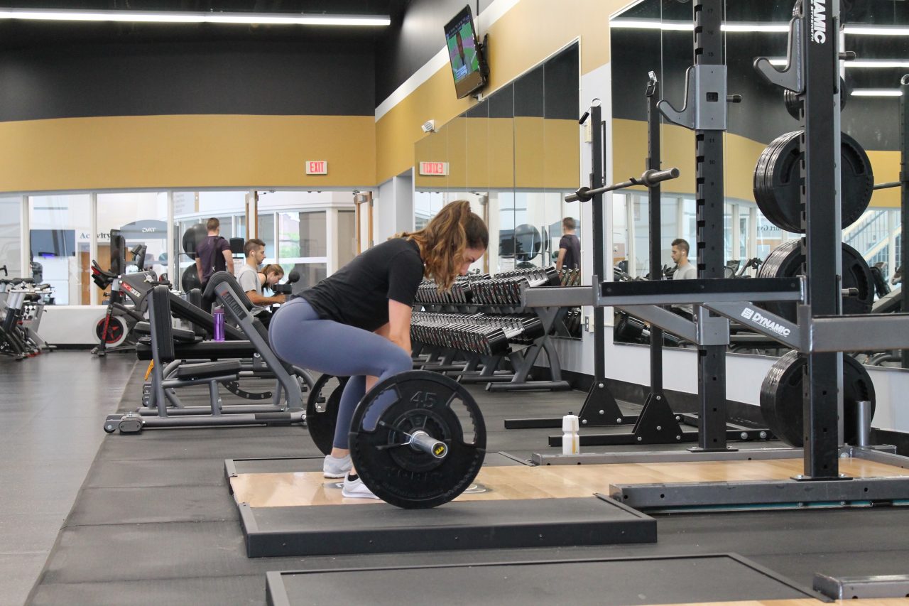 woman deadlifting gym