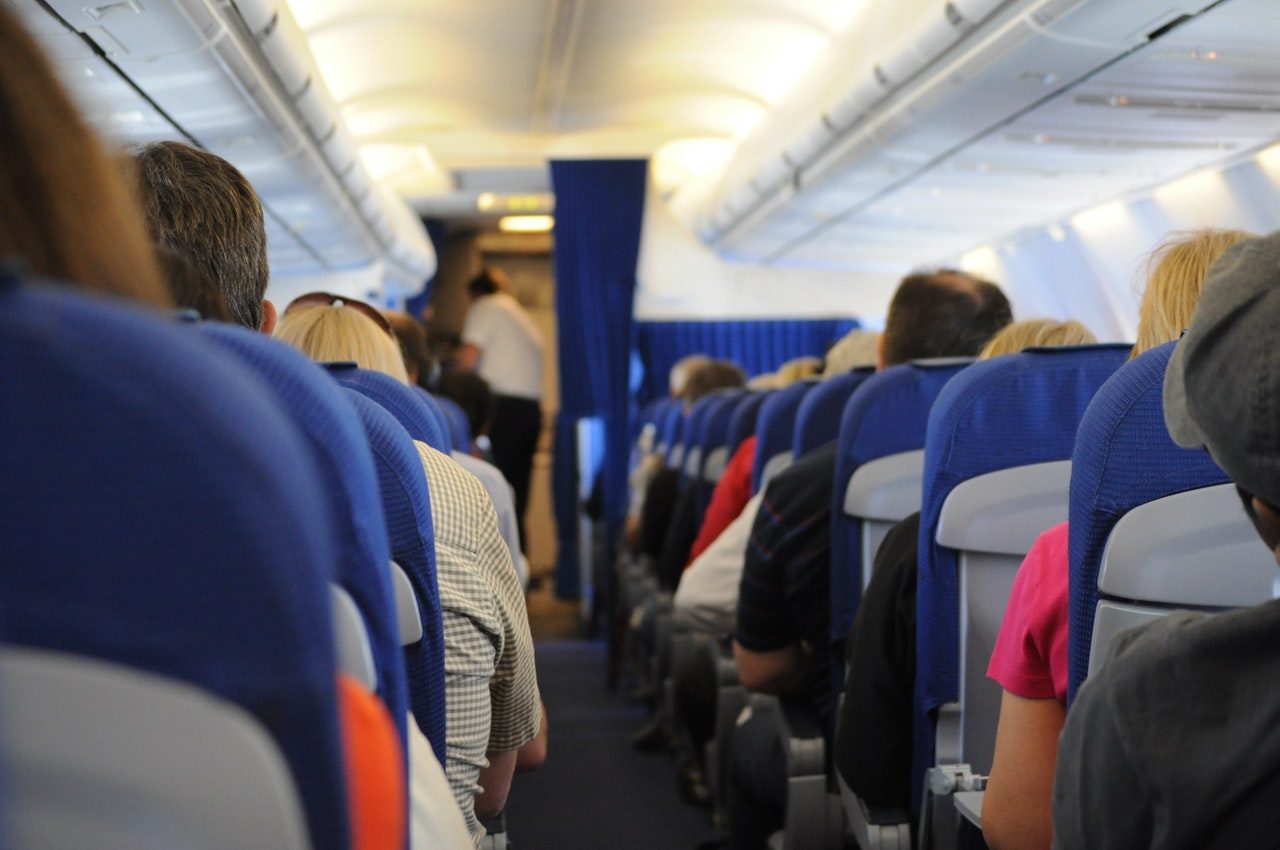 aisle of plane people sitting
