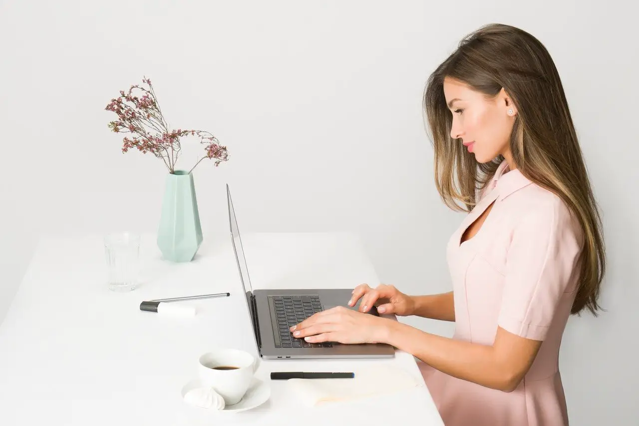 girl sitting at desk browsing laptop