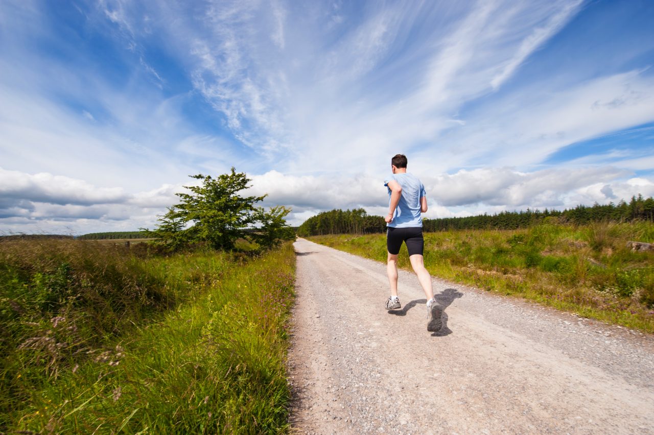 man running trail sunny