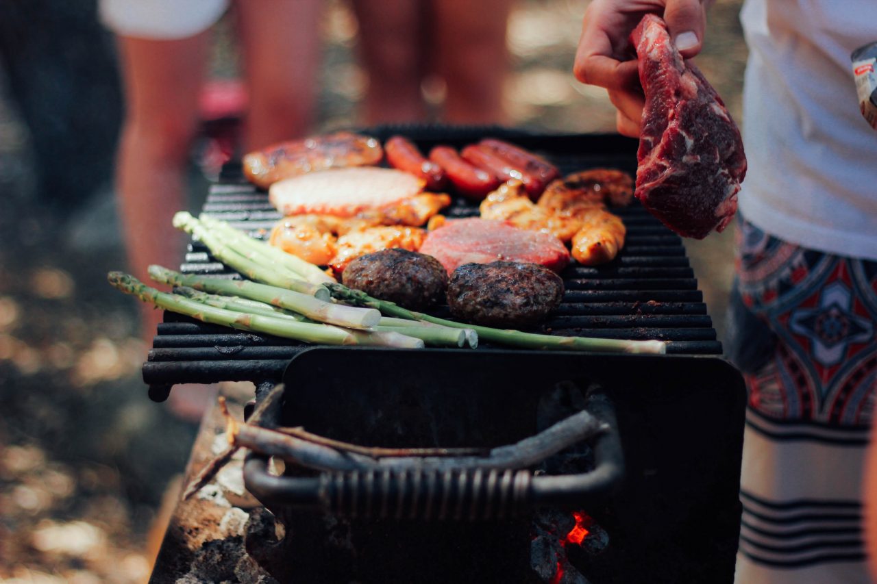 grilling assorted meats and asparagus