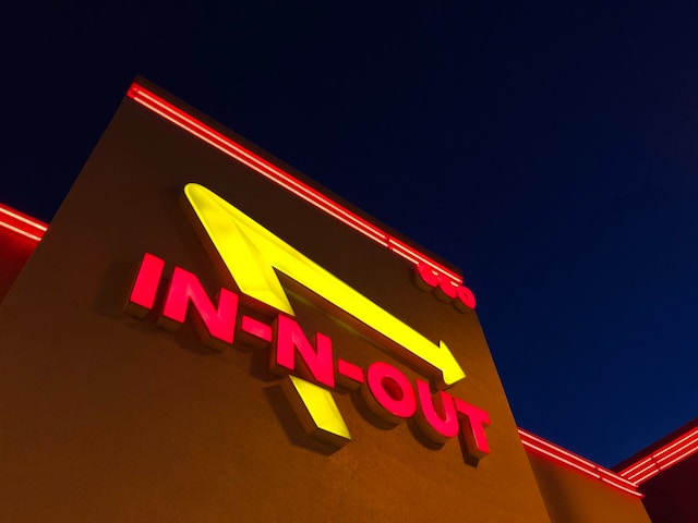 Neon In-N-Out sign on side of restaurant..