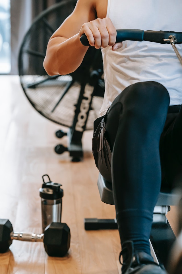 Muscular man training with gym equipment.