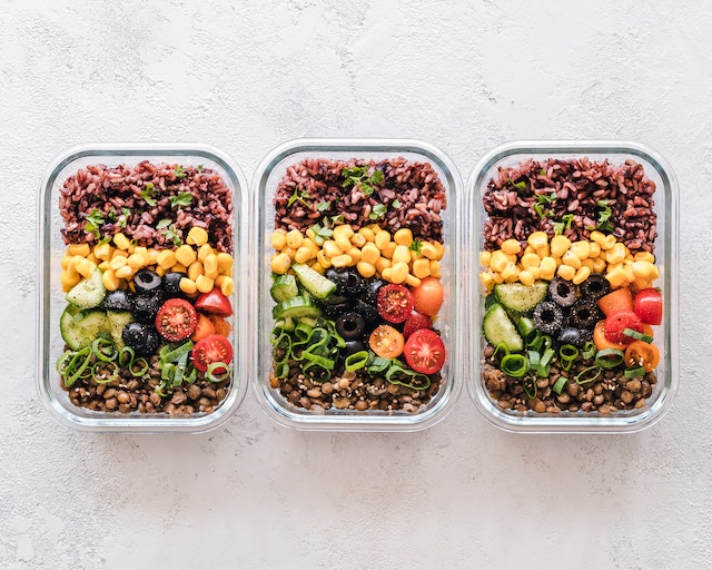 A photo of three meals in containers.