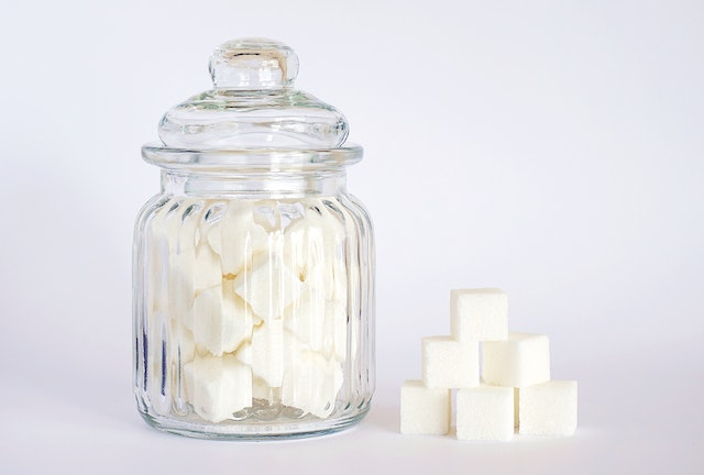 Close-up photo of a glass jar with sugar cubes inside it.