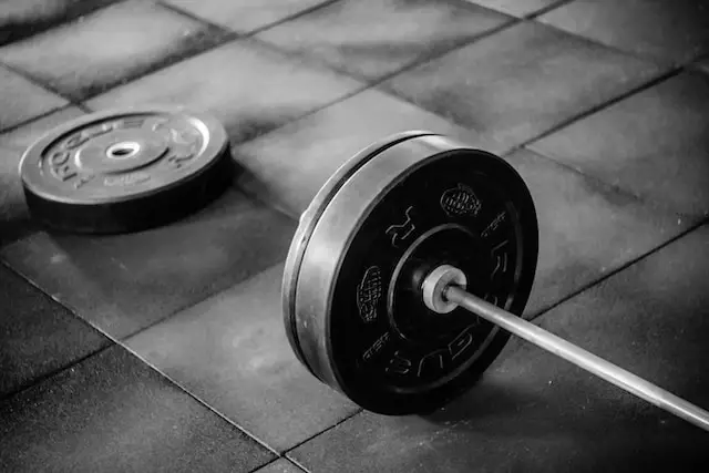 Barbell loaded with weights on the floor.