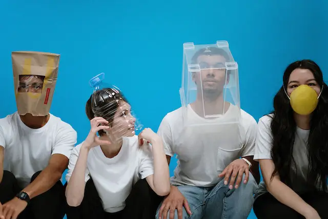 Four people wearing different types of DIY masks.