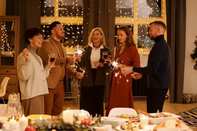 A family celebrating the holiday season while holding burning sparklers.