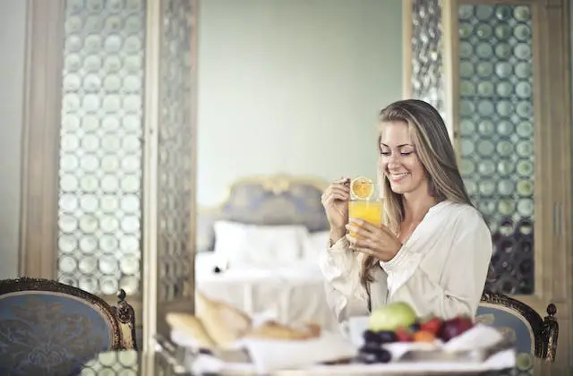  Smiling woman enjoying breakfast during the morning.