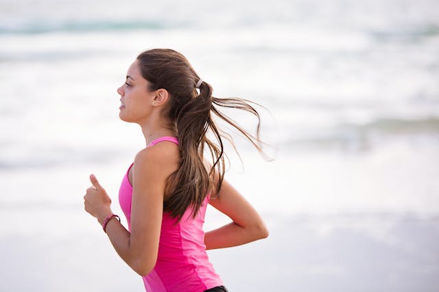 A running woman in pink sports wear.